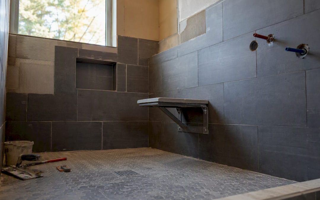 Mid-sized walk-in shower under construction with bench and niche