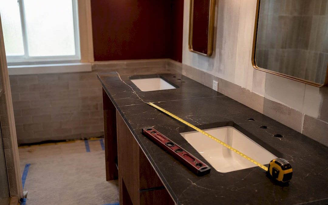Double sink vanity being measured during bathroom remodel