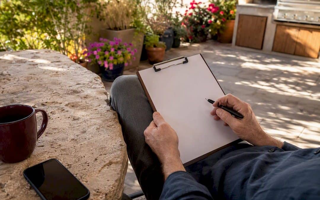 Hands holding contract clipboard at home