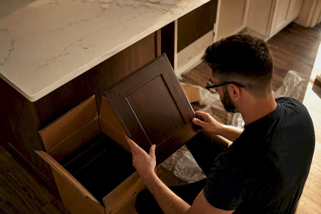 Hands Inspecting New Kitchen Cabinet Doors