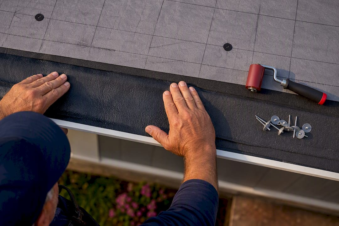 Installer Sealing Membrane At Roof Eave