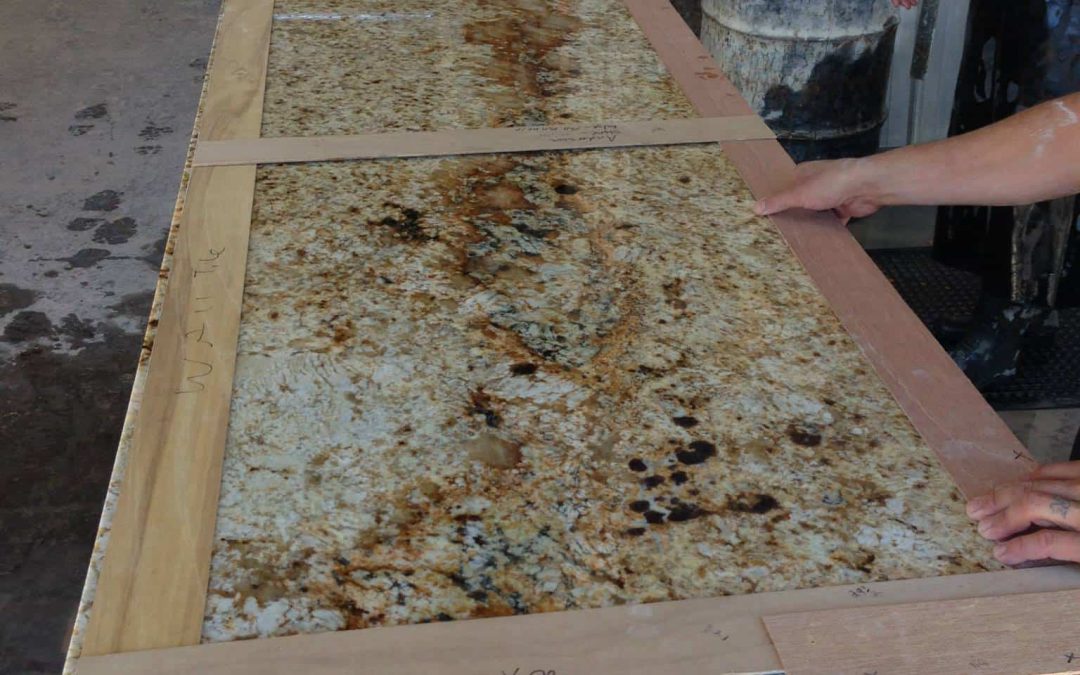 Showcase of fabricated natural stone and quartz edge profile cuts in a kitchen showroom