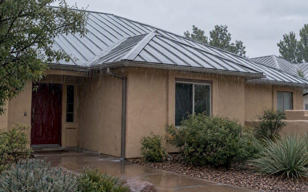 Rain falling on a residential standing-seam metal roof